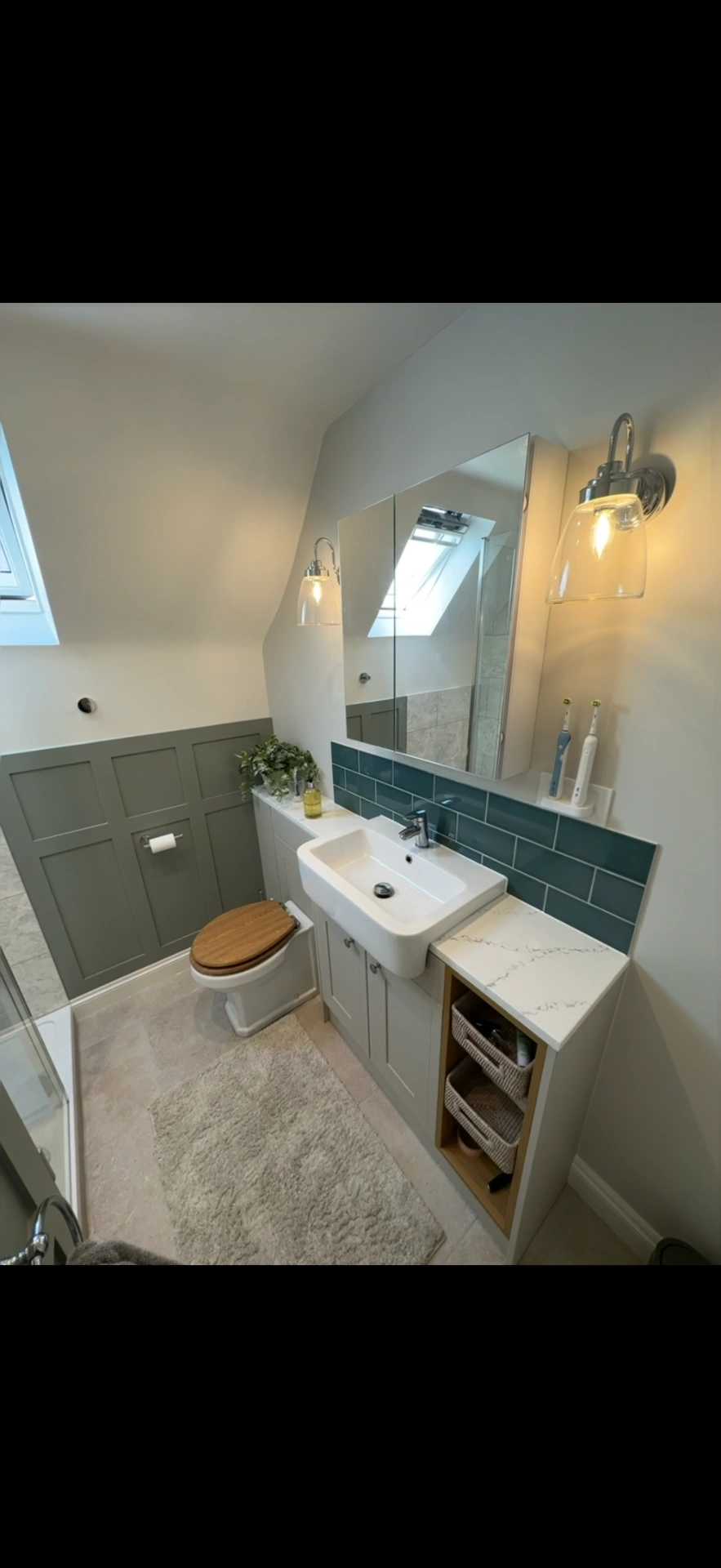 Loft cloakroom with sage panelling, teal tiles and fitted vanity — bathroom installers