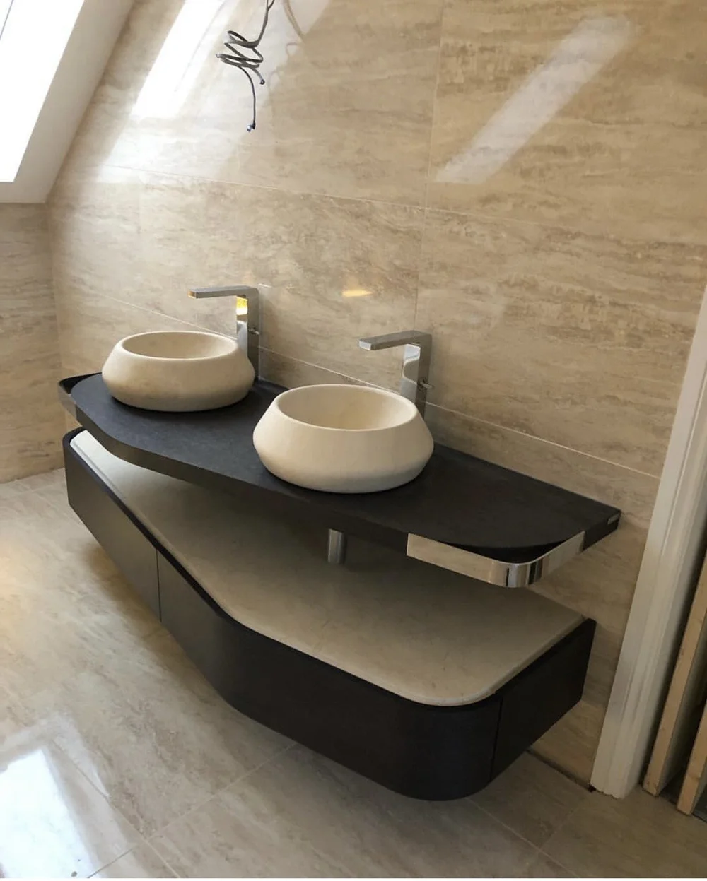 Bespoke twin stone vessel basins on curved slate vanity in travertine ensuite — bathroom design