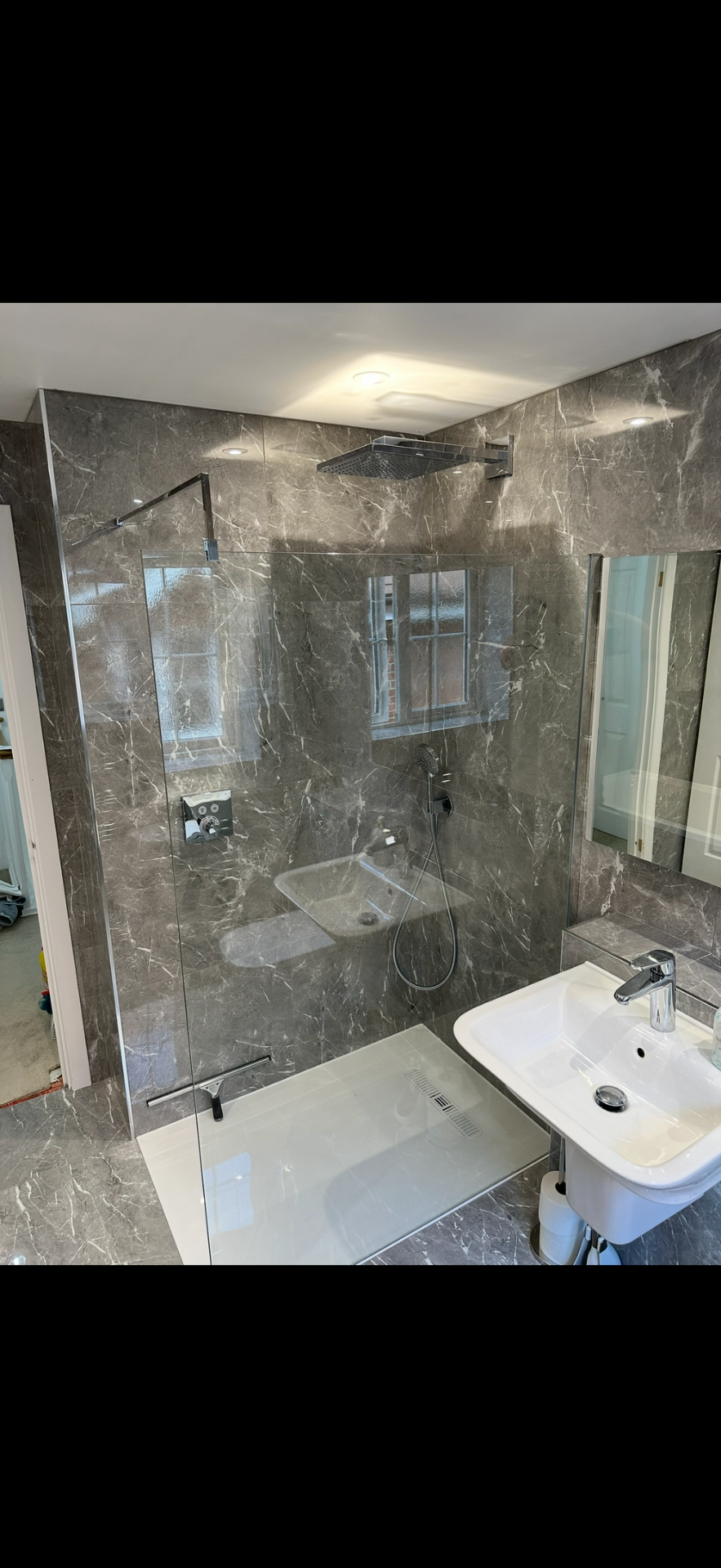 Grey marble walk-in shower with rainfall head and frameless glass — wet room