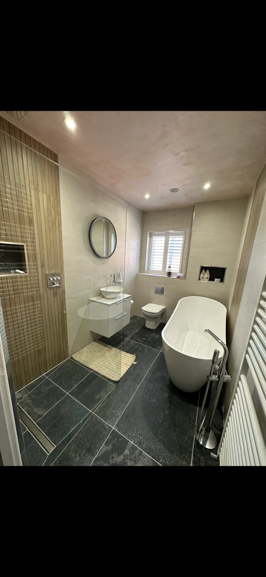 Master bathroom with freestanding tub, slate floor and oak-panelled walk-in shower — bathroom installation