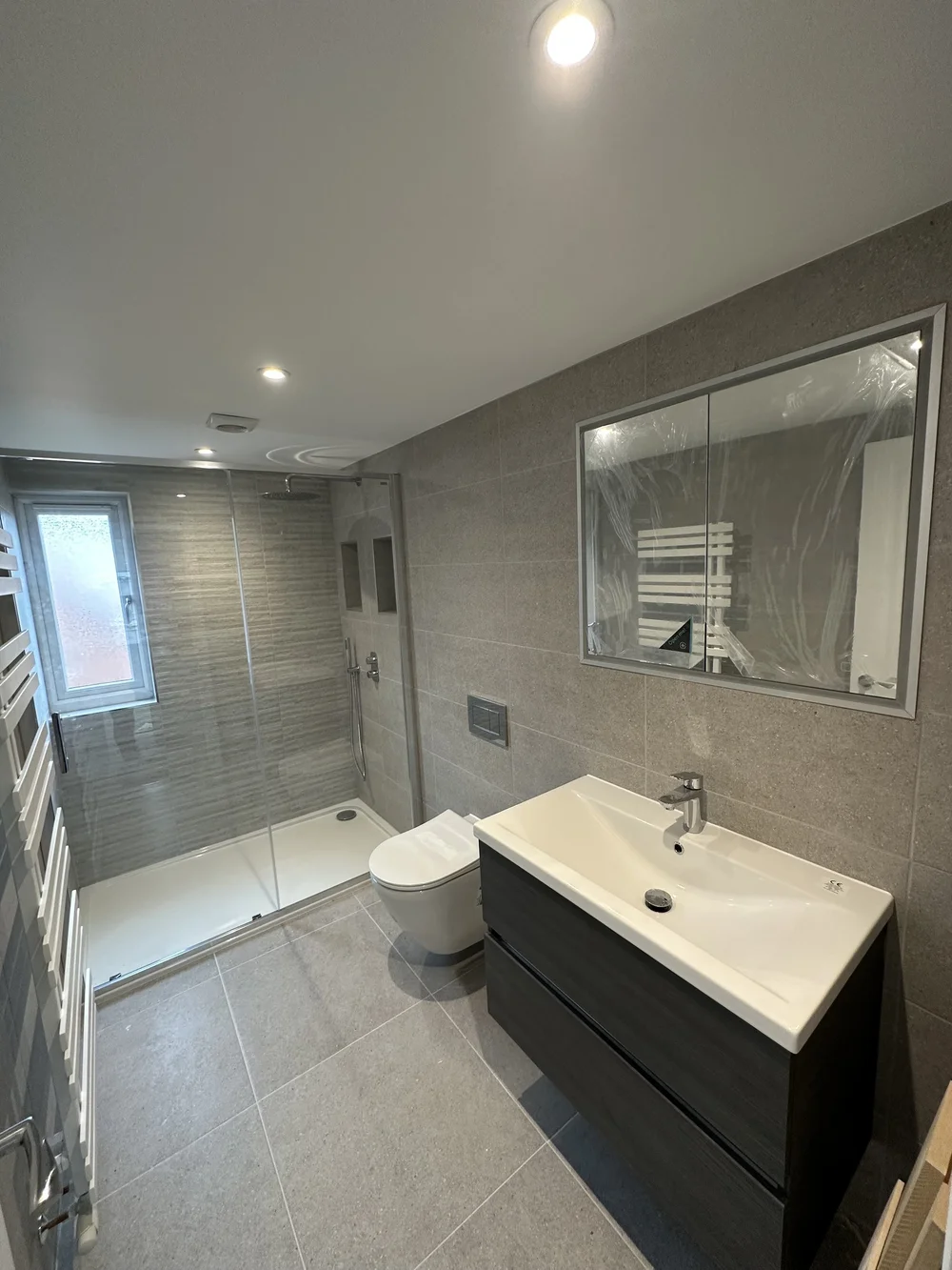 Contemporary shower room with graphite vanity, walk-in shower and mirrored cabinet — bathroom renovation