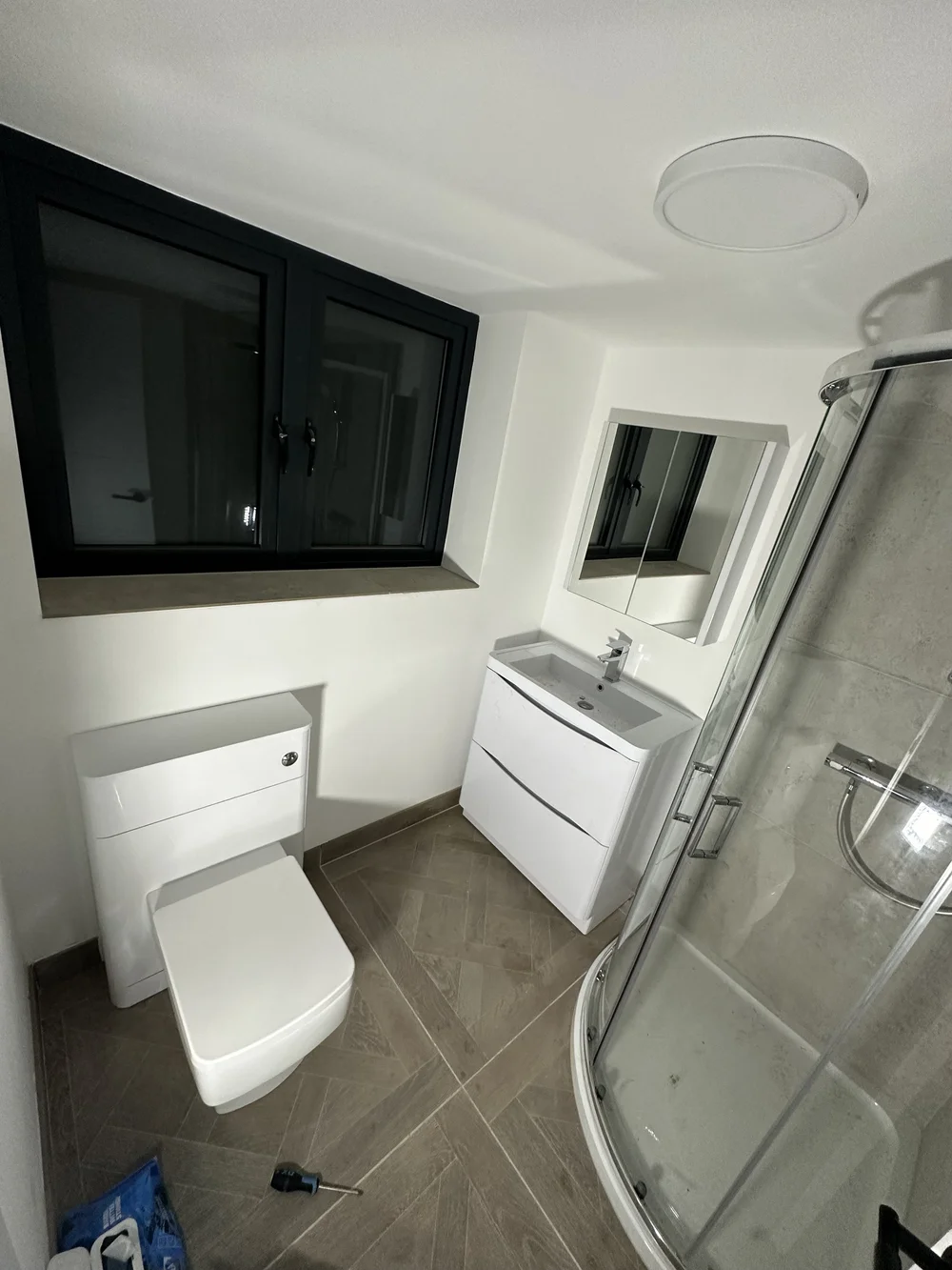 Compact ensuite with quadrant shower enclosure, wall-hung vanity and back-to-wall WC — bathroom installation in Reading