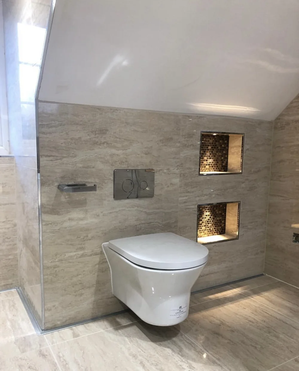 Travertine wet room with wall-hung WC and illuminated mosaic niches — bathroom renovation in Reading